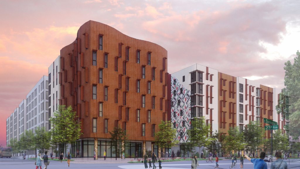 Contemporary apartment complex with a dynamic wooden exterior and contrasting white and patterned sections.