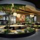 Biophilic office space with indoor plants, trees, and natural elements.