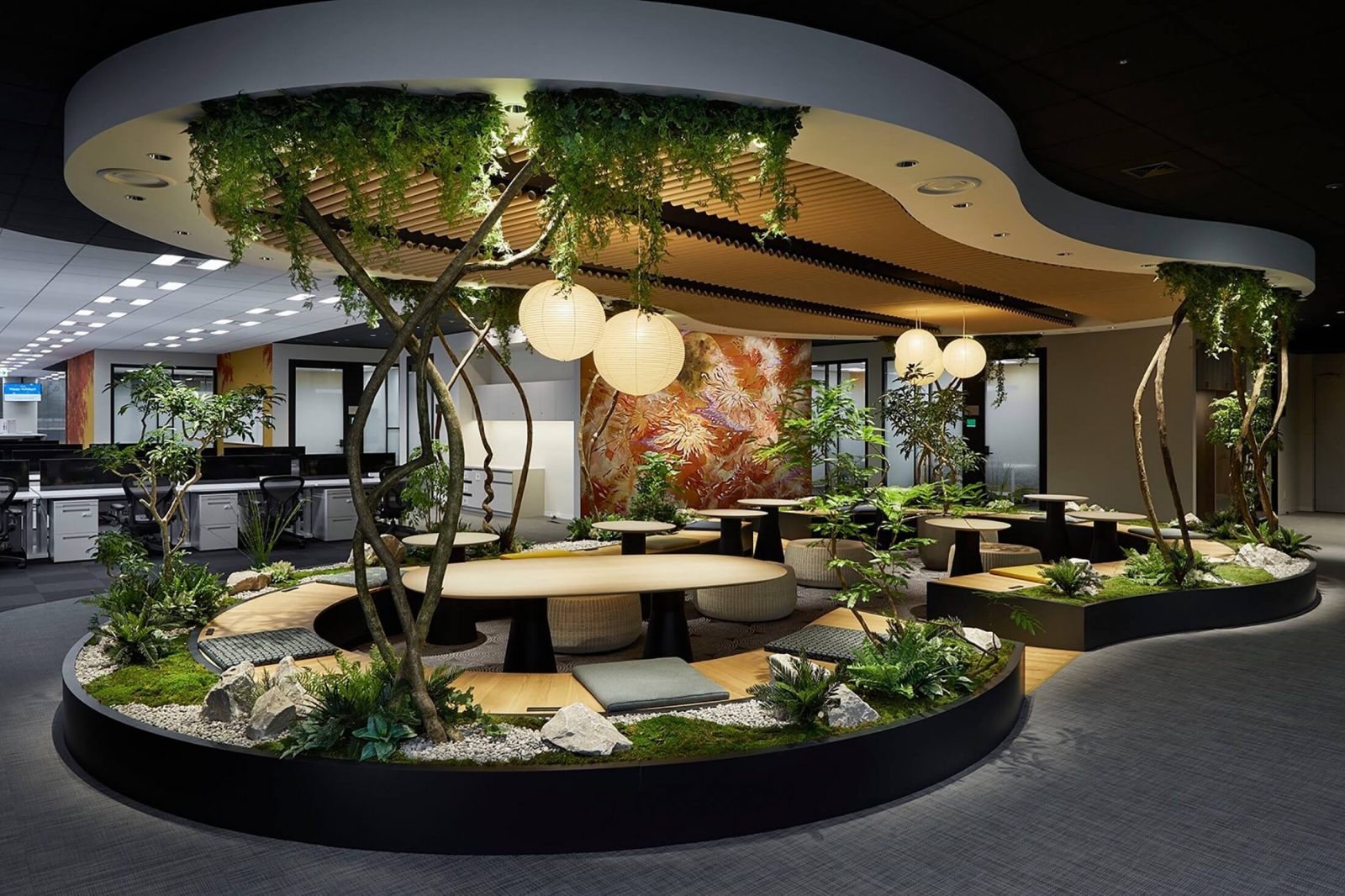 Biophilic office space with indoor plants, trees, and natural elements.