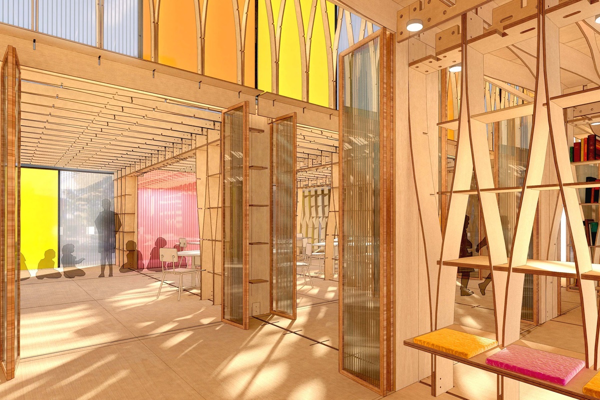 A brightly lit, open-plan interior with wooden structural elements, translucent partitions, and colorful accents, including yellow, orange, and red panels.