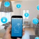 Smart home concept with icons for various connected devices floating around a phone.
