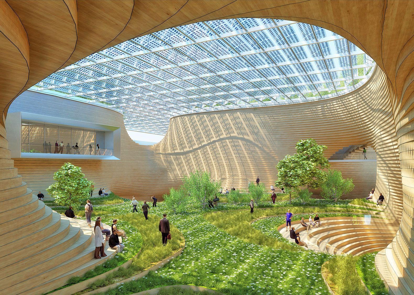 Indoor public space with a large grassy area, trees, wooden tiered seating, and a skylight roof covered in solar panels.