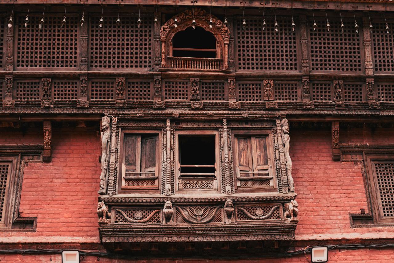 Intricate wooden window on a brick building